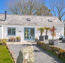 A house with plants and loungers in the garden at The Cowshed Portscatho
