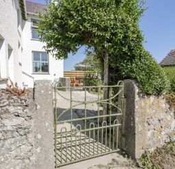 A green gate opening to a pathway at Ty Mawr Farm in Llanfairpwllgwyngyll