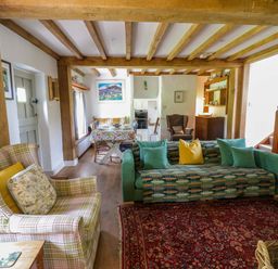 A living room with sofa and armchair at Cynefin in Newport, Pembrokeshire
