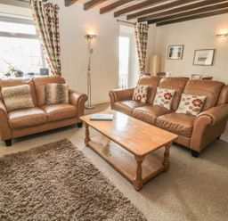 A living room with sofas and a coffee table at Shepherds Nook in Chathill