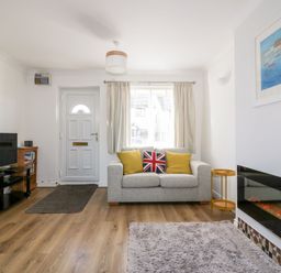 A living room with a sofa and television at Seahorses in Padstow