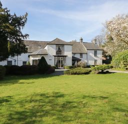 A house with a garden and trees at Plas Dolguog in Machynlleth