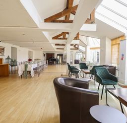 A dining room with tables and chairs at Plas Dolguog in Machynlleth