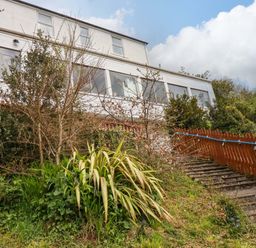 A house with stairs and plants leading to it at Flat 5 in Looe
