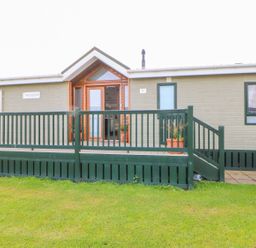 A front view of a property with a deck and potted plants at 37 Horizon Park in Hartlepool