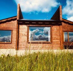 A wooden house with large windows and grass at No 4 Enniskillen