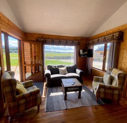 A living room with a sofa and two chairs at No 5 Enniskillen