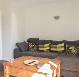 A living room with a sofa and coffee table at Carnweather in Newquay