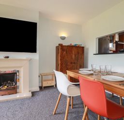 A dining room with a table and chairs at Carnweather in Newquay