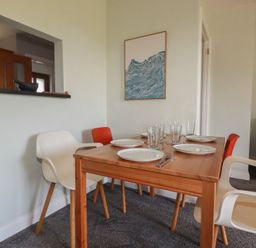 A dining room with a table set for a meal at Carnweather in Newquay