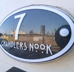 A nameplate with the text '7 Chandlers Nook' and a reflection at Chandlers Nook in Portland