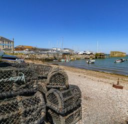 A waterfront scene with boats and fishing traps at Chandlers Nook in Portland