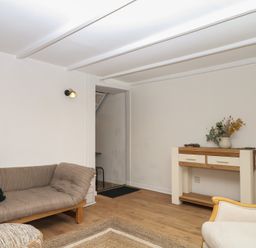 A living room with a sofa and table at Bedford Cottage in Yelverton