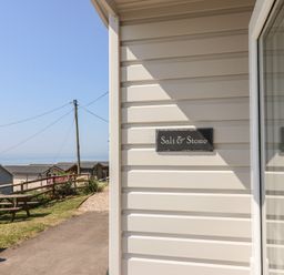 A view of the exterior signage for Salt & Stone in Lyme Regis