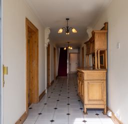 A hallway with a sideboard and staircase at Ballyneill Farmhouse, Carrick-On-Suir, County Tipperary