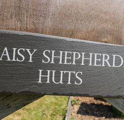 A sign that reads Daisy Shepherd's Huts in South Molton