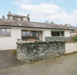 A house with a stone wall and garden at Ambwray in Ambleside