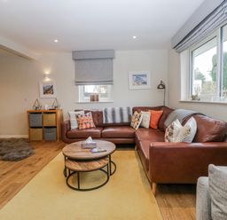 A living room with a sofa and coffee table at Ambwray in Ambleside