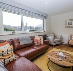 A living room with a sofa and coffee table at Ambwray in Ambleside