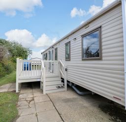 A mobile home with steps leading to a deck at PK Sunset View in Corton