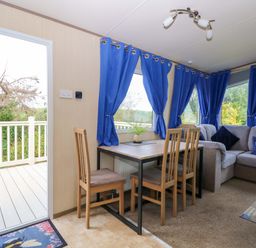A dining area with a table and chairs at PK Sunset View in Corton