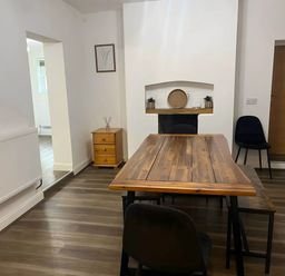 A dining room with a table and chairs at Llangollen - House - Sleeps 8- Garden in Llangollen