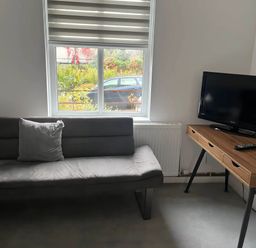 A living room with a sofa and television at Llangollen - House - Sleeps 8- Garden in Llangollen