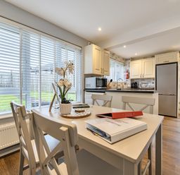 A kitchen with a table and chairs at 2 Bed House - Sleeps 4 - Garden - Parking - Wifi in Kendal