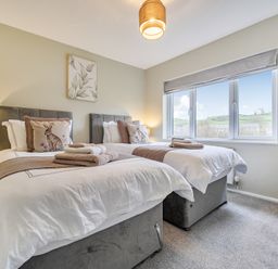 A bedroom with two beds and window at 2 Bed House - Sleeps 4 - Garden - Parking - Wifi Kendal