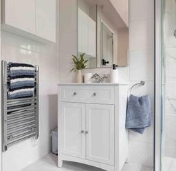 A bathroom with a sink and towel rack at Cotswolds Cozy Cottage Retreat - pet friendly, Finstock