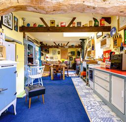 A kitchen with furniture and various decorations at Family Country Cottage with a private Valley View