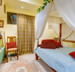A bedroom with a bed and seating area at Family Country Cottage with a private Valley View