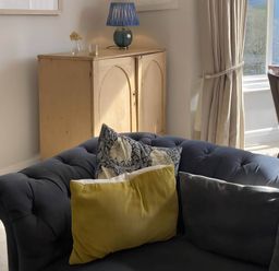 A living room with a sofa and cushions at Beachside 2-Bed - Sleeps 4, Parking & Pet Friendly, Salcombe