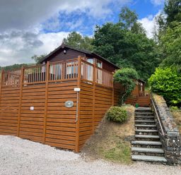 A lodge with decking and steps leading up to it at 2 Bed Lodge-Sleeps 4-stunning views -Pet Friendly in Troutbeck