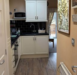 A kitchen with cabinets and appliances at 2 Bed Lodge-Sleeps 4-stunning views -Pet Friendly, Troutbeck