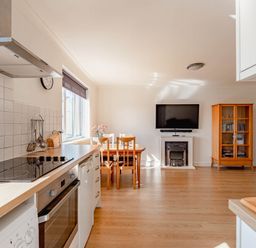 A kitchen with a dining area and television at Luxury 2 Bed Room Lake View Apt Bowness Parking Bowness-On-Windermere