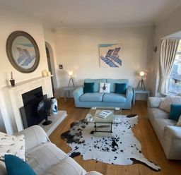 A living room with a fireplace and sofas at 4 Bed House-Sleeps 8-Parking-Pets-MarinaSeaView in Torquay