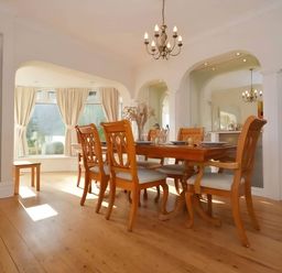 A dining room with a table and chairs at 4 Bed House-Sleeps 8-Parking-Pets-MarinaSeaView in Torquay