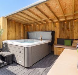 An outdoor space featuring a hot tub and seating area at Sea View, East Parade, Llandudno