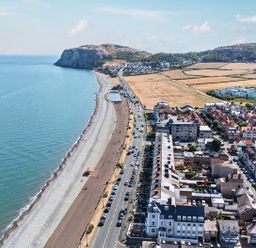 A coastline with beach and buildings at Sea View, East Parade Llandudno