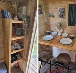 A kitchen with a table set for dining at Restored circus wagon in Saltburn-By-The-Sea