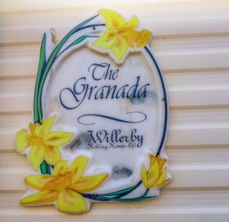 A sign for The Granada by Willerby at Caravan at Argraig Llanrhyddlad near Cemaes Bay