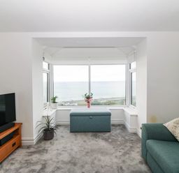 A living room with a view of the sea at Briar Bank in Barmouth