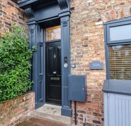 An entrance with a black door and a mailbox at Blacksmiths Retreat in York