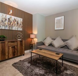 A living room with a sofa and coffee table at Blacksmiths Retreat, York
