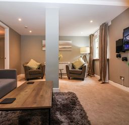 A living room with seating and a television at Blacksmiths Retreat in York