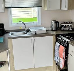 A kitchen with a sink and appliances at Static Caravan Hoburne Devon Bay in Paignton