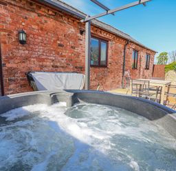 A hot tub in an outdoor area at Elwy Cottage in St Asaph