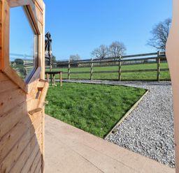 An outdoor area with a view of grass and a fence at Antlers Lodge in Biddulph Moor