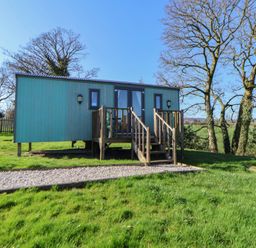 A cabin with steps in the garden at Shepherds Delight Biddulph Moor